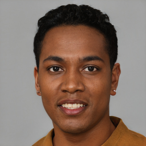 Joyful black young-adult male with short  black hair and brown eyes