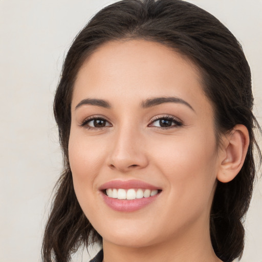 Joyful white young-adult female with long  brown hair and brown eyes