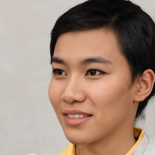 Joyful asian young-adult female with short  black hair and brown eyes