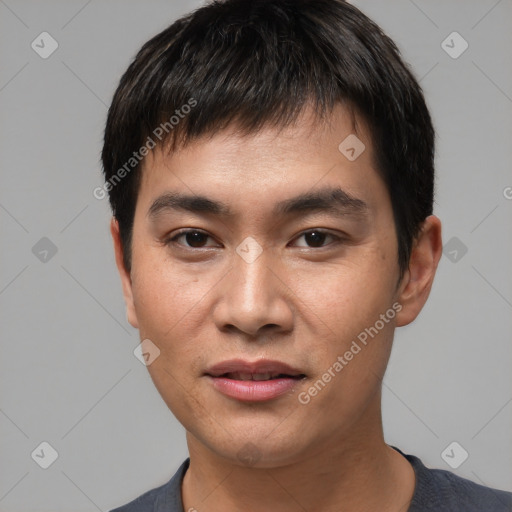 Joyful asian young-adult male with short  black hair and brown eyes