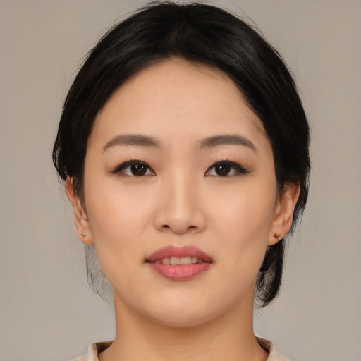 Joyful asian young-adult female with medium  black hair and brown eyes