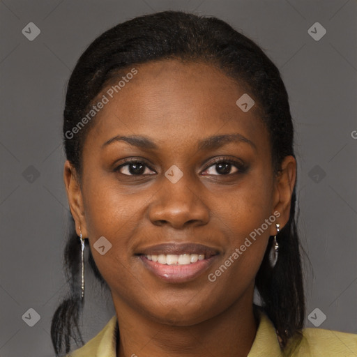 Joyful black young-adult female with long  brown hair and brown eyes