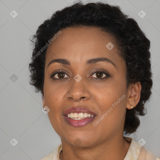 Joyful black young-adult female with long  brown hair and brown eyes