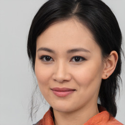 Joyful asian young-adult female with medium  black hair and brown eyes