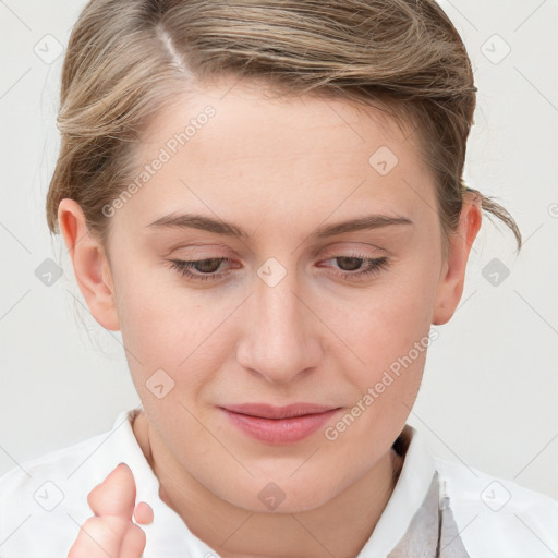 Joyful white young-adult female with short  brown hair and blue eyes