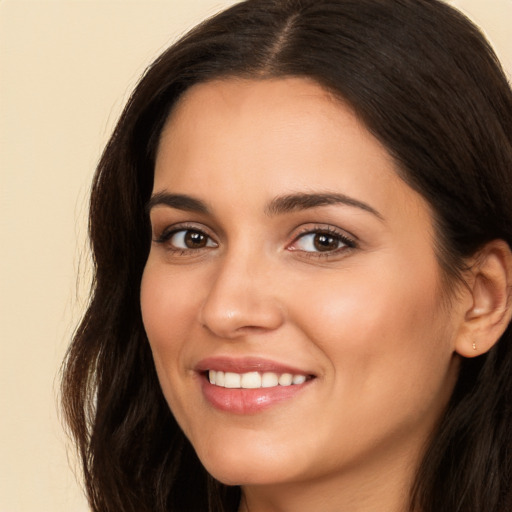 Joyful white young-adult female with long  brown hair and brown eyes