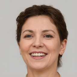 Joyful white adult female with short  brown hair and brown eyes