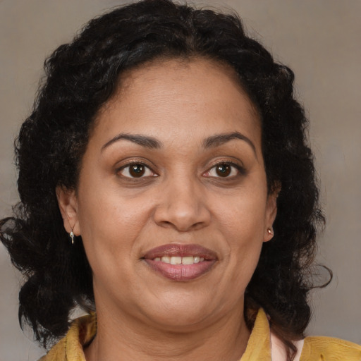 Joyful black adult female with medium  brown hair and brown eyes