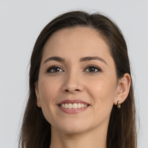 Joyful white young-adult female with long  brown hair and brown eyes