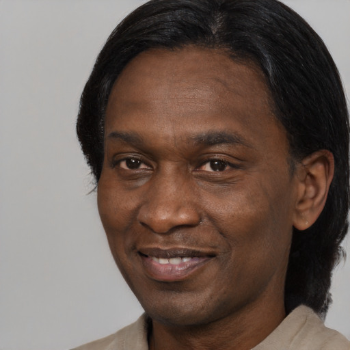 Joyful black adult male with medium  brown hair and brown eyes