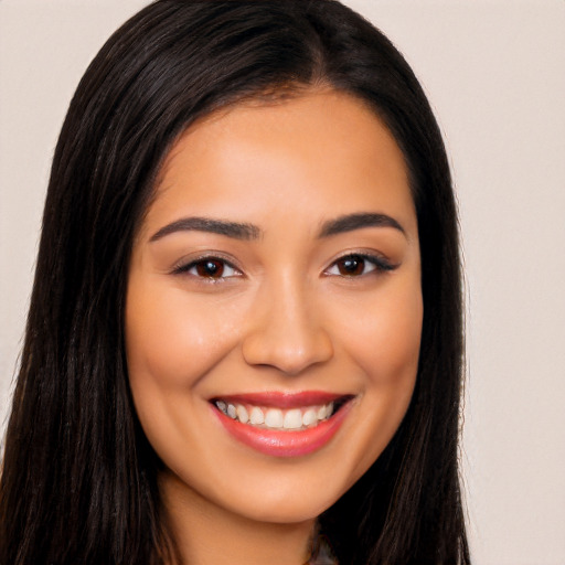 Joyful latino young-adult female with long  black hair and brown eyes