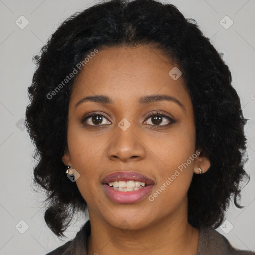 Joyful black young-adult female with long  black hair and brown eyes