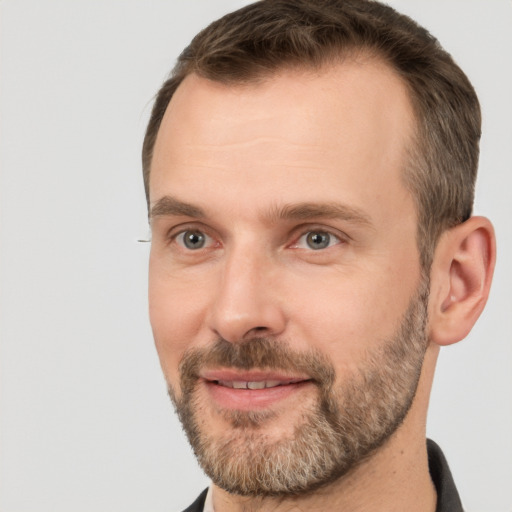 Joyful white adult male with short  brown hair and brown eyes