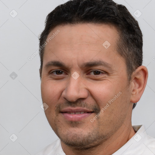 Joyful white adult male with short  brown hair and brown eyes