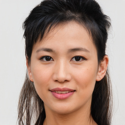 Joyful asian young-adult female with long  brown hair and brown eyes
