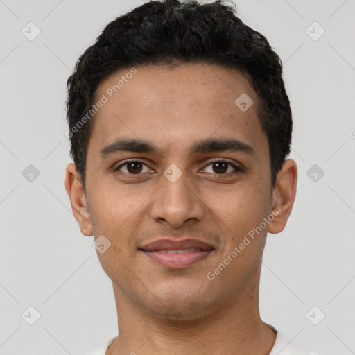 Joyful latino young-adult male with short  brown hair and brown eyes