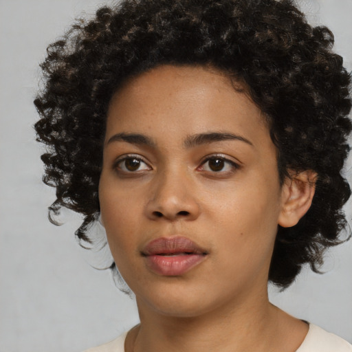 Neutral black young-adult female with medium  brown hair and brown eyes