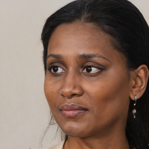 Joyful black adult female with medium  black hair and brown eyes
