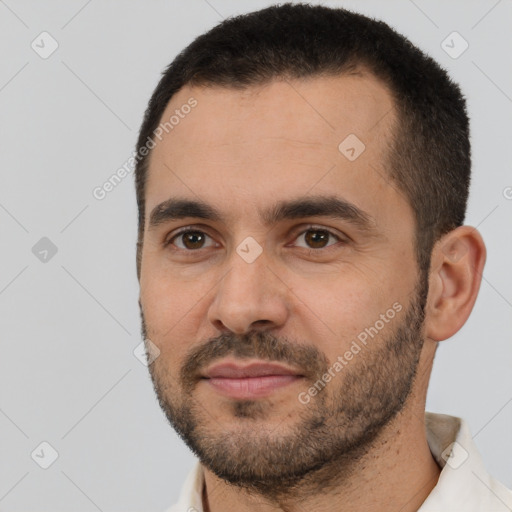 Joyful white young-adult male with short  black hair and brown eyes