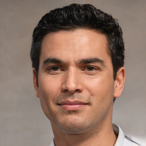 Joyful white young-adult male with short  black hair and brown eyes