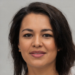 Joyful asian young-adult female with long  brown hair and brown eyes