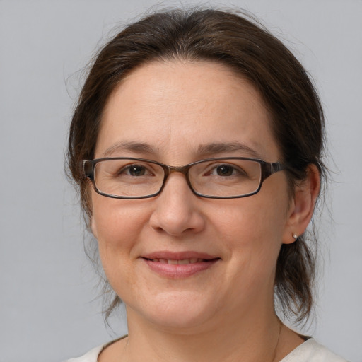 Joyful white adult female with medium  brown hair and brown eyes