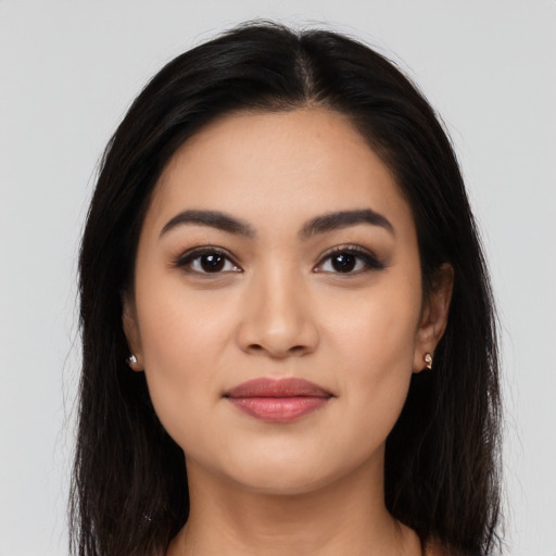 Joyful latino young-adult female with long  brown hair and brown eyes