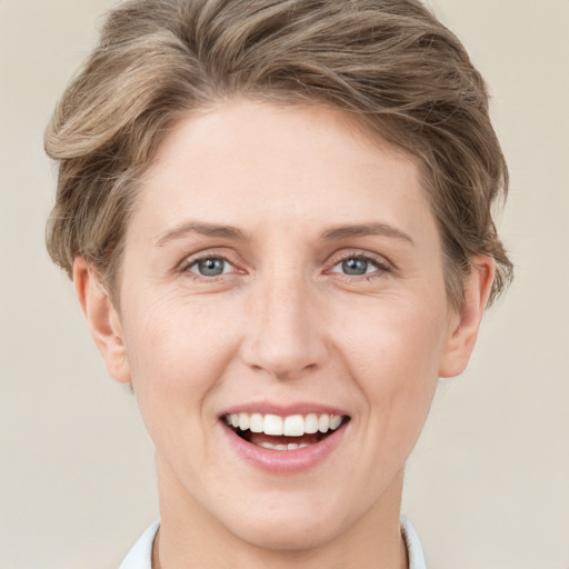 Joyful white young-adult female with short  brown hair and grey eyes