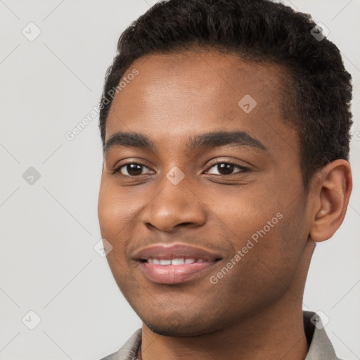 Joyful black young-adult male with short  brown hair and brown eyes