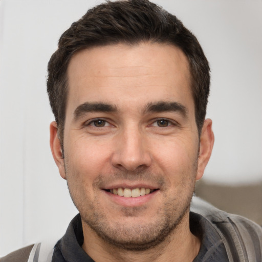 Joyful white young-adult male with short  brown hair and brown eyes