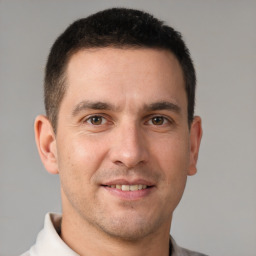 Joyful white adult male with short  brown hair and brown eyes