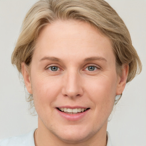 Joyful white young-adult female with medium  brown hair and blue eyes