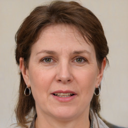 Joyful white adult female with medium  brown hair and blue eyes