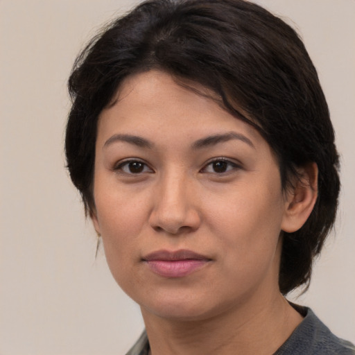 Joyful asian young-adult female with medium  brown hair and brown eyes