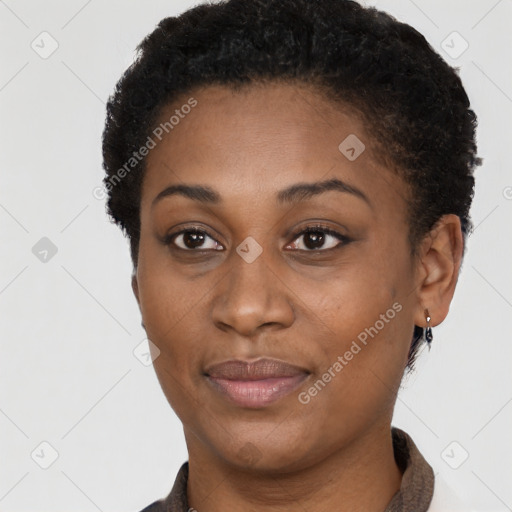 Joyful black young-adult female with short  black hair and brown eyes