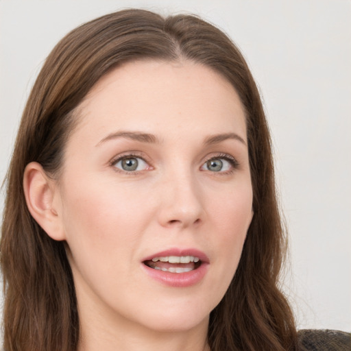 Joyful white young-adult female with long  brown hair and blue eyes