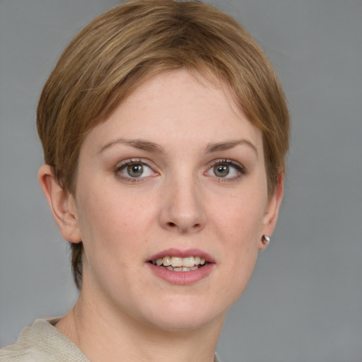 Joyful white young-adult female with short  brown hair and grey eyes