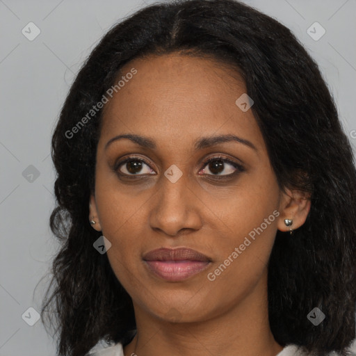 Joyful black young-adult female with long  brown hair and brown eyes