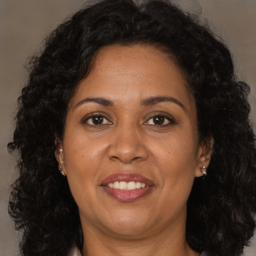 Joyful latino adult female with long  brown hair and brown eyes