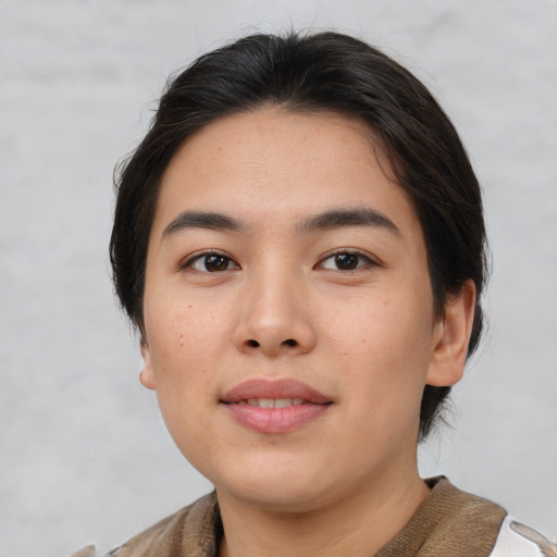 Joyful asian young-adult female with medium  brown hair and brown eyes