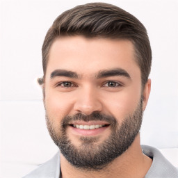 Joyful white young-adult male with short  black hair and brown eyes