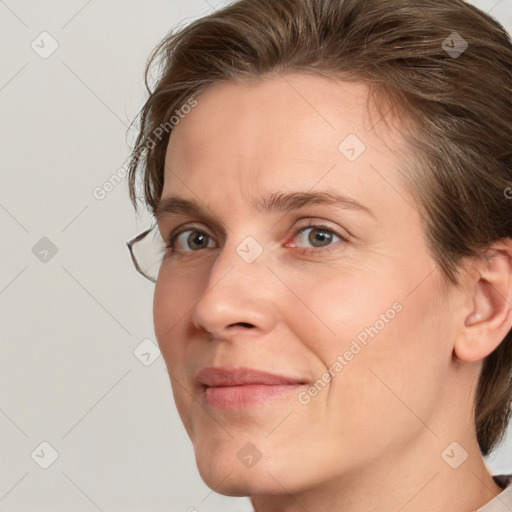 Joyful white adult female with medium  brown hair and grey eyes