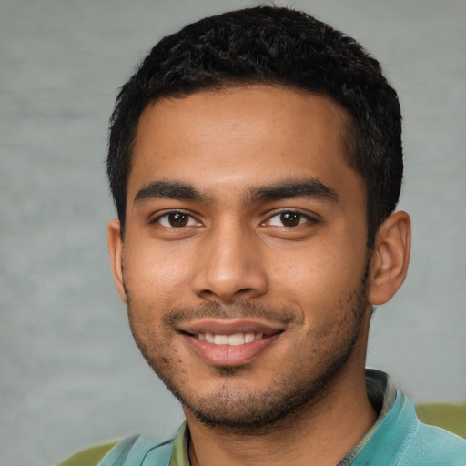 Joyful latino young-adult male with short  black hair and brown eyes