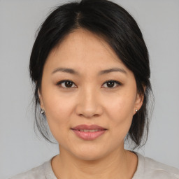 Joyful asian young-adult female with medium  brown hair and brown eyes