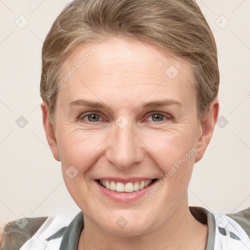 Joyful white adult female with short  brown hair and grey eyes