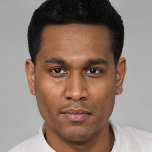 Neutral latino young-adult male with short  black hair and brown eyes