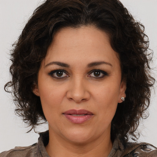 Joyful white adult female with long  brown hair and brown eyes