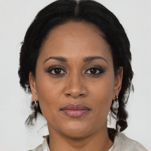 Joyful black adult female with medium  black hair and brown eyes