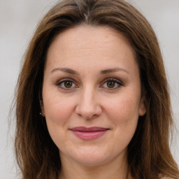 Joyful white adult female with long  brown hair and brown eyes