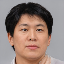 Neutral asian adult male with short  brown hair and brown eyes